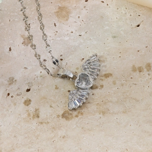 Macro shot of silver angel wing heart pendant necklace with sparkling cubic zirconia