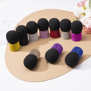 Luxury rhinestone-encrusted makeup brushes with soft black sponge heads displayed