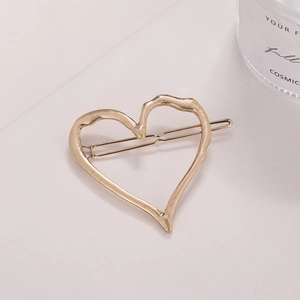 Irregular hollow heart hair clip in gold finish with elegant molten metal texture