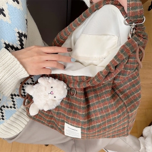 Detail of tweed checkered tote interior with zipper pocket and large capacity storage