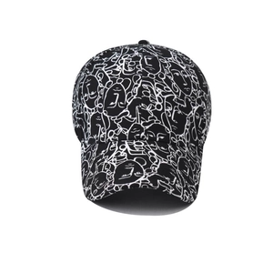 Detail view of cotton baseball cap featuring white abstract line art face print on black