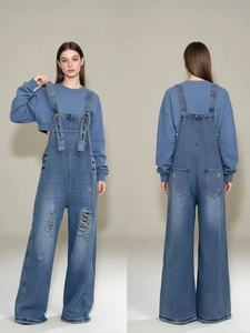 Front and back view of vintage blue distressed denim overalls with ripped wide-leg details