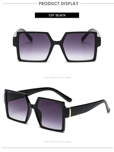 Detail view of retro oversized square sunglasses with black frames and gradient lenses