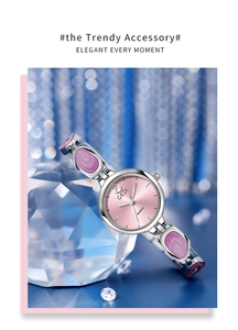 Close-up of pink marble style bracelet watch resting on a crystal prism display