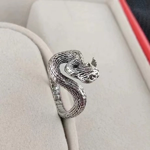 Macro shot of antique silver snake ring showing detailed scale texture and vintage finish