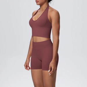 Detail of seamless ribbed high waist shorts and halter yoga bra in deep rose finish