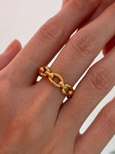 Close-up of golden hollow chain ring with heart motif on a model finger