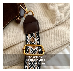 Close-up of geometric woven shoulder strap with gold metal buckle and lobster clasp detail