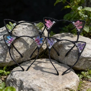 Handmade cat ear headbands with colorful natural crystals on a natural stone surface
