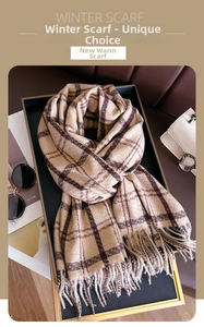 Detail of classic beige and brown plaid winter scarf with fringe on a display tray