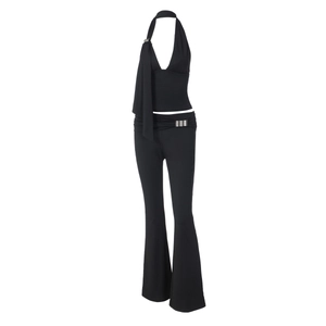 Detail of black backless halter top and high-waisted flared trousers two-piece set