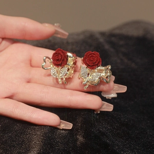 Pair of red velvet rose hair claws with rhinestone leaves on elegant gold metal