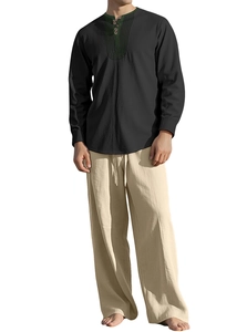 Detail of men's linen beach set showing ethnic embroidery and cotton fabric texture