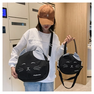Detail of cute cat-shaped black canvas bags showing crossbody and handbag strap styles