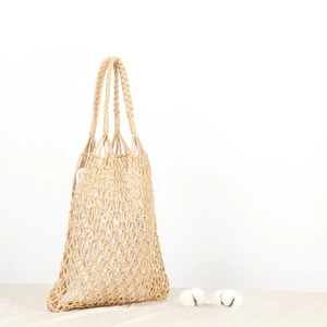 Detailed macro view of woven hollow cotton rope bag with textured fabric and white inner lining
