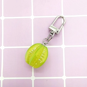 Detailed view of a green mini carambola keychain with silver D-ring and chain