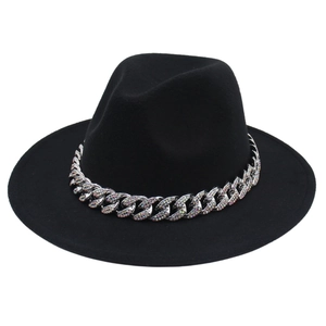 Detail of a black felt fedora hat featuring a chunky silver chain with inlaid crystals