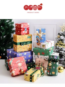 Close-up of colorful Christmas wrapping paper with Santa patterns, ribbons, and bells