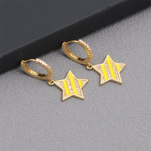 Macro shot of gold star earrings with yellow enamel stripes and zircon inlays