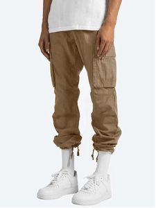 Close-up of khaki cargo pants with multiple utility pockets and drawstring detail