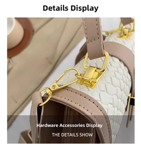 Close-up of white woven texture handbag with beige leather trim and gold metal hardware