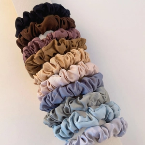 Set of colorful satin silk scrunchies in diverse shades with a smooth glossy texture