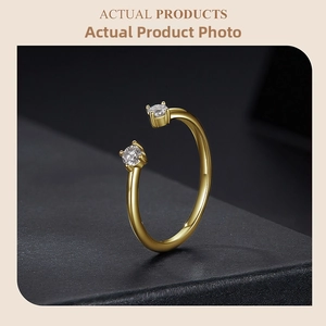 Detail of gold-plated open ring featuring two round-cut sparkling moissanite stones