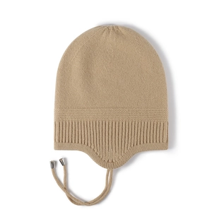 Winter knitted beanie for women with earflaps and strap in soft beige wool fabric
