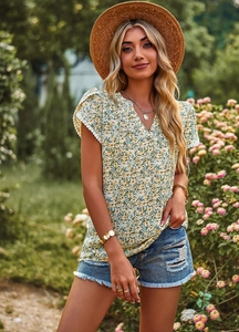 Detailed view of V-neck short sleeve shirt with lace cuffs and colorful floral print