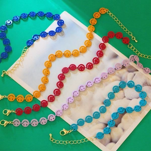 Close-up of colorful smiley face bracelets with adjustable golden lobster clasp chains