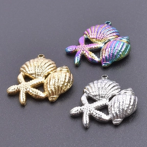 Detailed view of starfish and seashell charms in gold, silver, and iridescent finishes