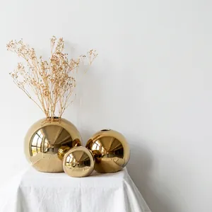Set of three luxury gold electroplated spherical ceramic vases for elegant home decor accents