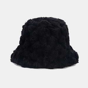 Detailed view of the soft black faux fur texture and brim of the plush bucket hat