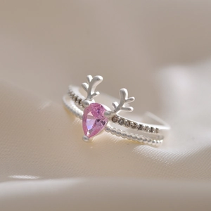 Macro shot of silver deer antler ring featuring a pink teardrop gemstone and zircon