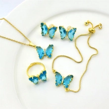 Detailed set of gold butterfly jewelry including necklace, ring, earrings and bracelet