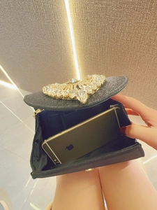 Internal view of black glitter evening clutch bag showing space for a smartphone