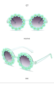 Detailed front and side views of light green daisy flower sunglasses for kids, model C7