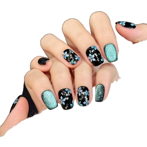 Black and light blue floral press-on nails with gold foil and mint glitter accents
