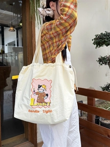 Cute off-white canvas tote bag with cat embroidery and drawstring detail for women