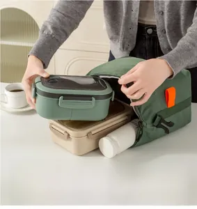 Putting a 1200ml green lunch box and water bottle into a canvas insulated thermal bag