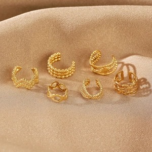 Detailed set of six gold-plated cuff earrings on premium champagne silk fabric