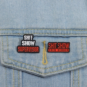 Funny Shit Show Supervisor black enamel pin set on denim jacket pocket