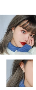 Detail showing vintage silver smiley face hoop earrings on model with macro ear close-up