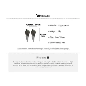 Macro view of long black tassel earrings with zircon stones and silver needles details