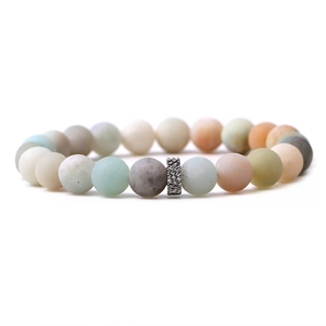 Close-up of matte natural stone beads in pastel colors with a silver hollow spacer bead