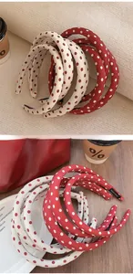 Detail of red and cream polka dot sponge headbands with handmade decorative labels
