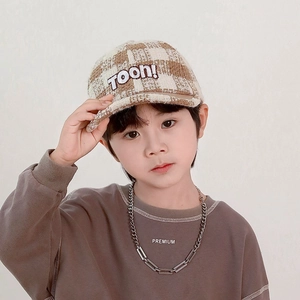 Detail of embroidered TOON! text on a plaid tweed baseball cap for boys and girls