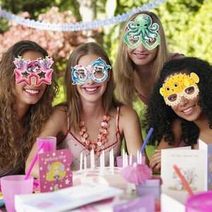 Women wearing ocean-themed paper party glasses featuring sea turtles and dolphins