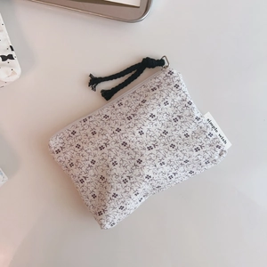 Close-up of floral cotton pouch with zipper, cotton rope pull and Simple Wish label