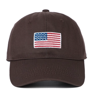 Detail of American flag embroidery on a dark brown soft cotton baseball cap